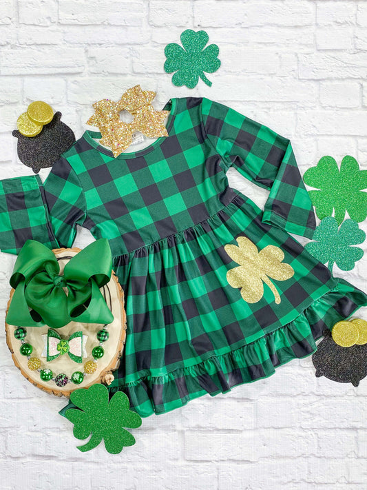 Green buffalo plaid St. Patrick's Day dress with gold shamrock design. 