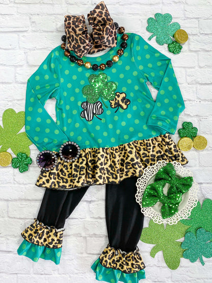 Polka dot tunic with sequin and animal print shamrock design, and black ruffle pants. 