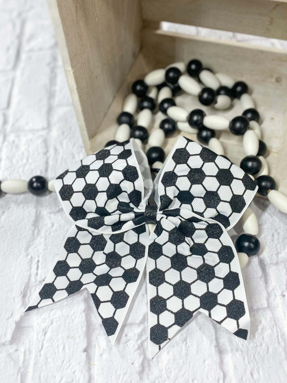 Cheer style bow in a soccer ball print ribbon.