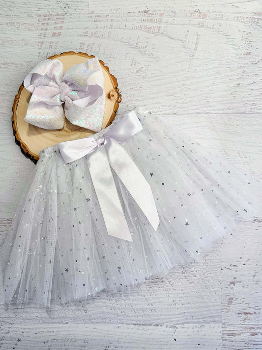 White tulle tied tutu (tulle is looped around the elastic waist) with sparkle stars and white bow accent.