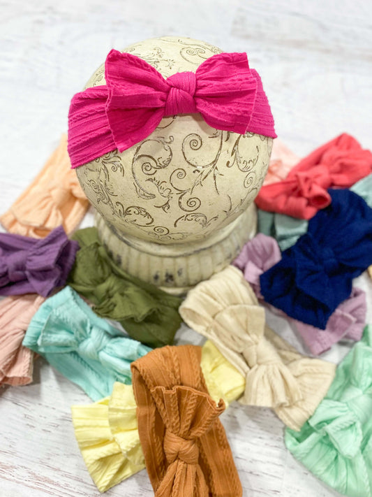 Cable knit bow headbands in a variety of colors