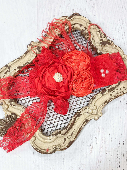 Vintage style lace headband with red flowers and lace embellishments.