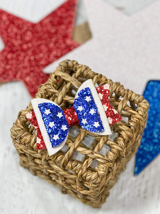 Glitter covered red, white, and blue bow hair clip with alligator clip backing