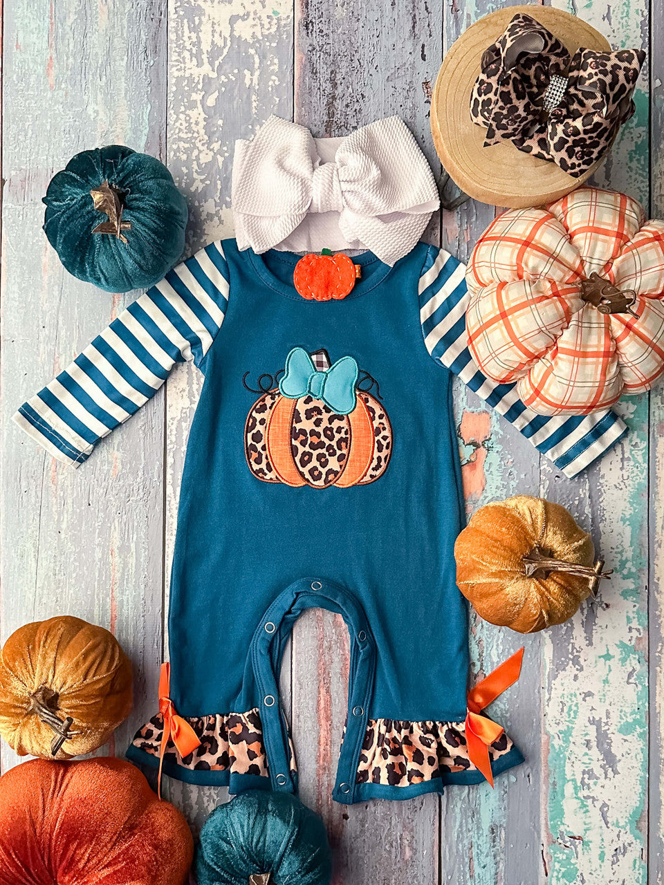 Blue, orange, and animal print pumpkin with a blue bow, striped long sleeves, animal print ruffles, and two orange bows romper.