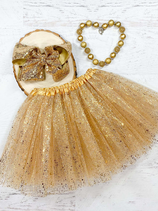 Gold tulle tutu with a metallic gold "splatter." The waist is a stretchy satin lined material to fit a wide age range and the tulle skirt is about 11."  Available in one size only, this tutu fits most kids between 2-8 years.