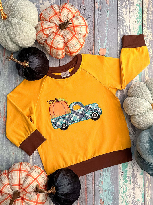 Mustard long sleeve shirt with brown trim and a truck and pumpkin appliqué.
