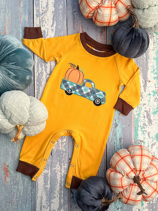 Mustard long sleeve romper with brown trim and a truck and pumpkin appliqué. 