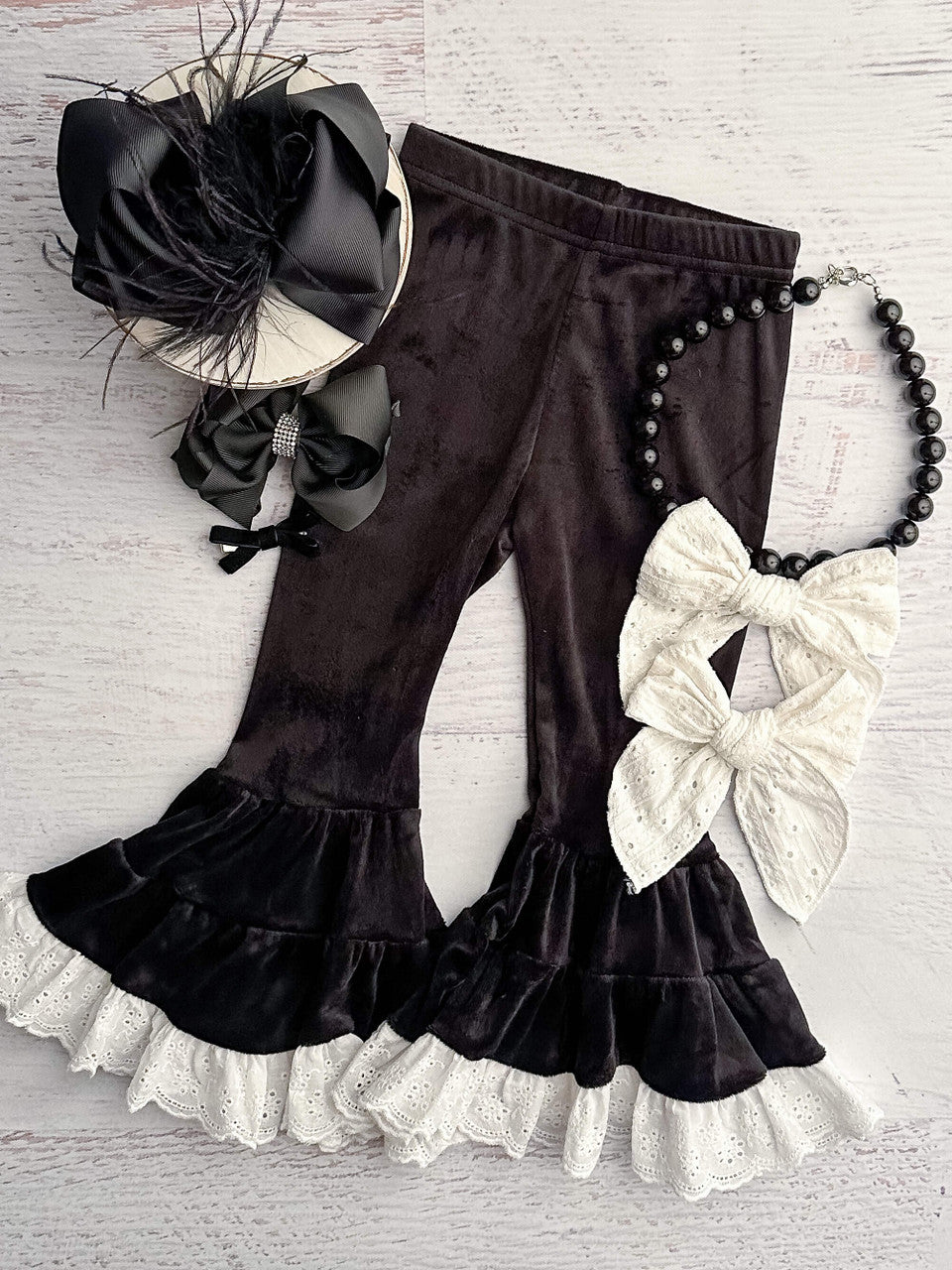 Black velvet leggings with white lace trim.