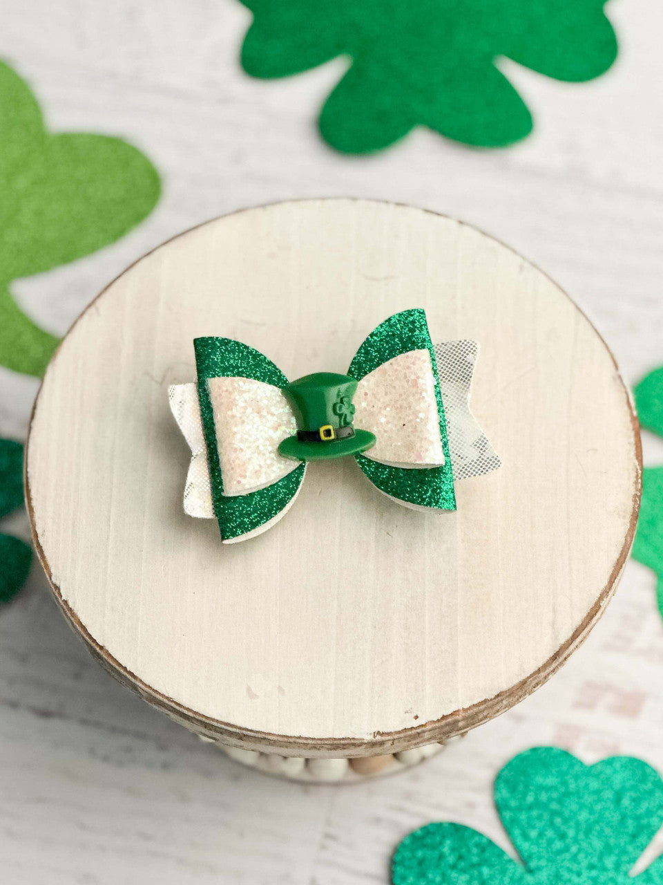 Green and white glitter layered bow with leprechaun hat center.