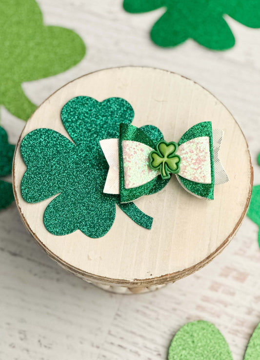 Green and white glittered layer bow with clover center.