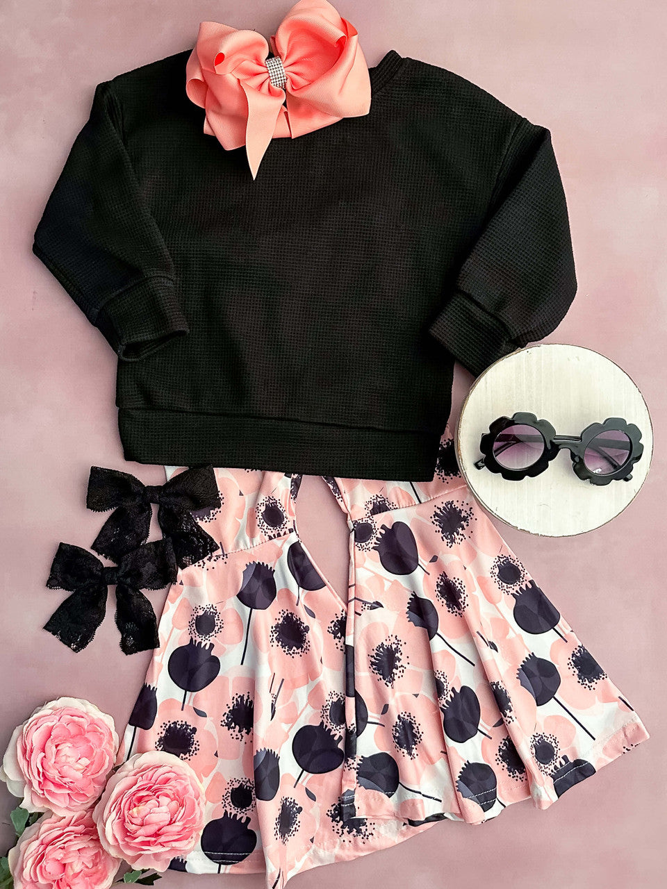 Black long sleeve waffle knit top with pink poppy bell bottom pants