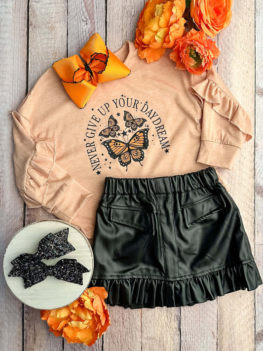 Tan long sleeve top with butterfly design with black ruffled skirt