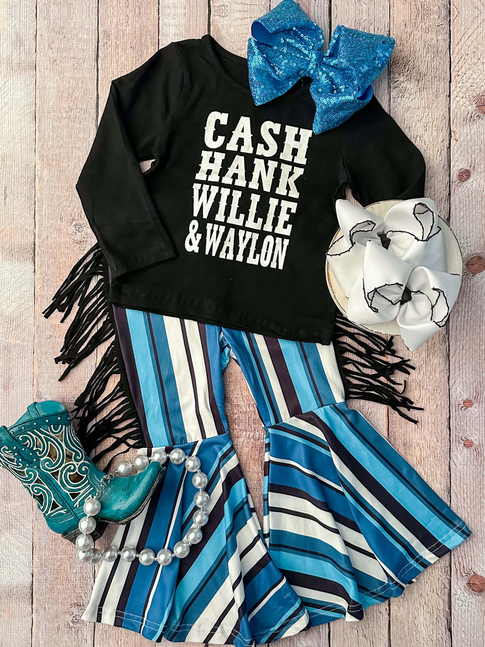 Black long sleeve shirt that says Cash Hank Willie & Waylon with hues of blue stripes and fringe bell bottom pants