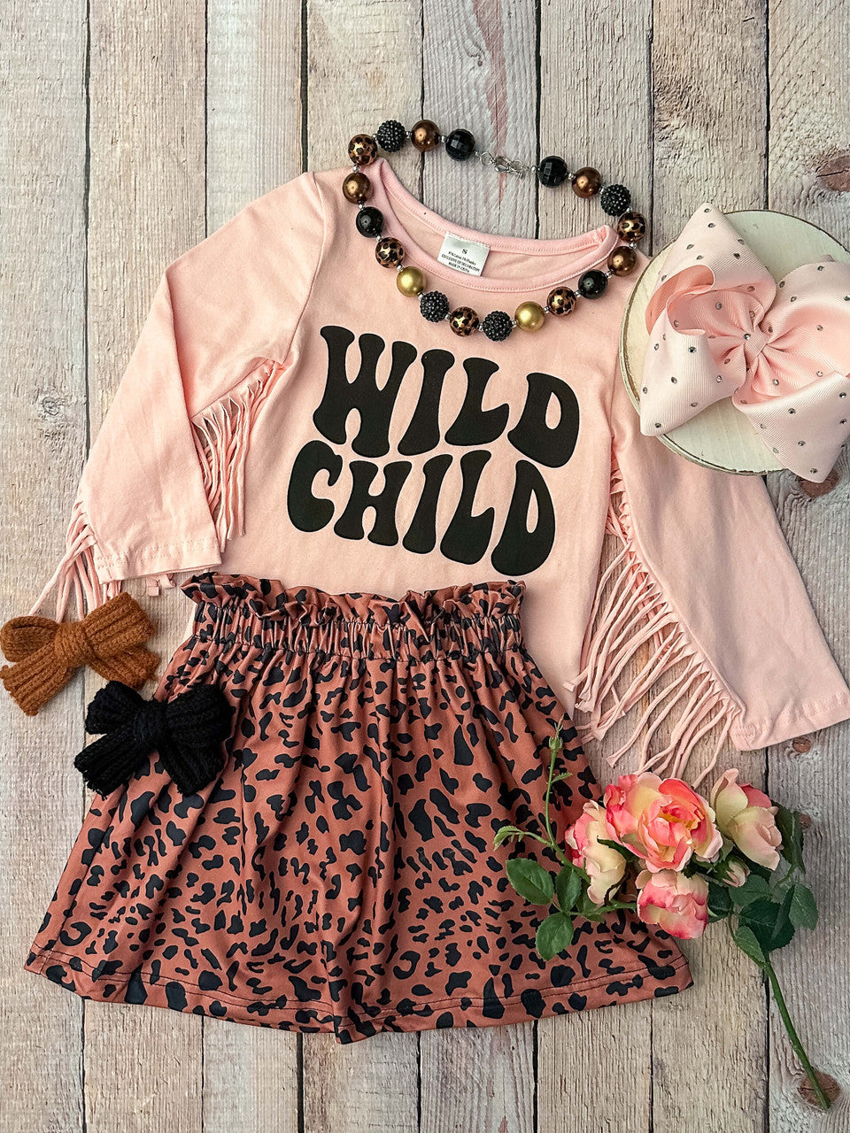 Pink long sleeve fringe top with Wild Child design with animal print skirt