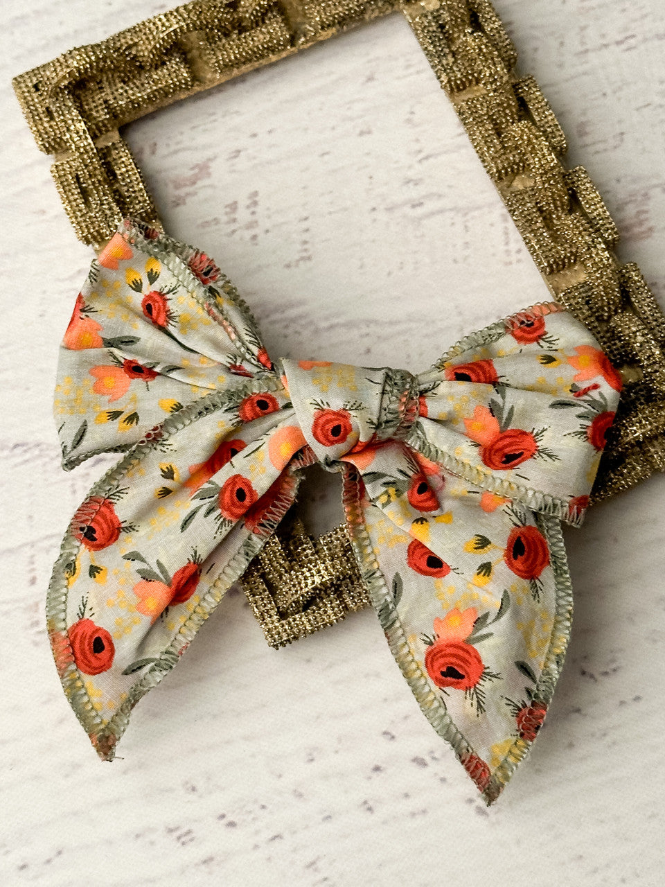 Floral print bow with a removable single alligator clip. Measures approximately 5x5 inches.