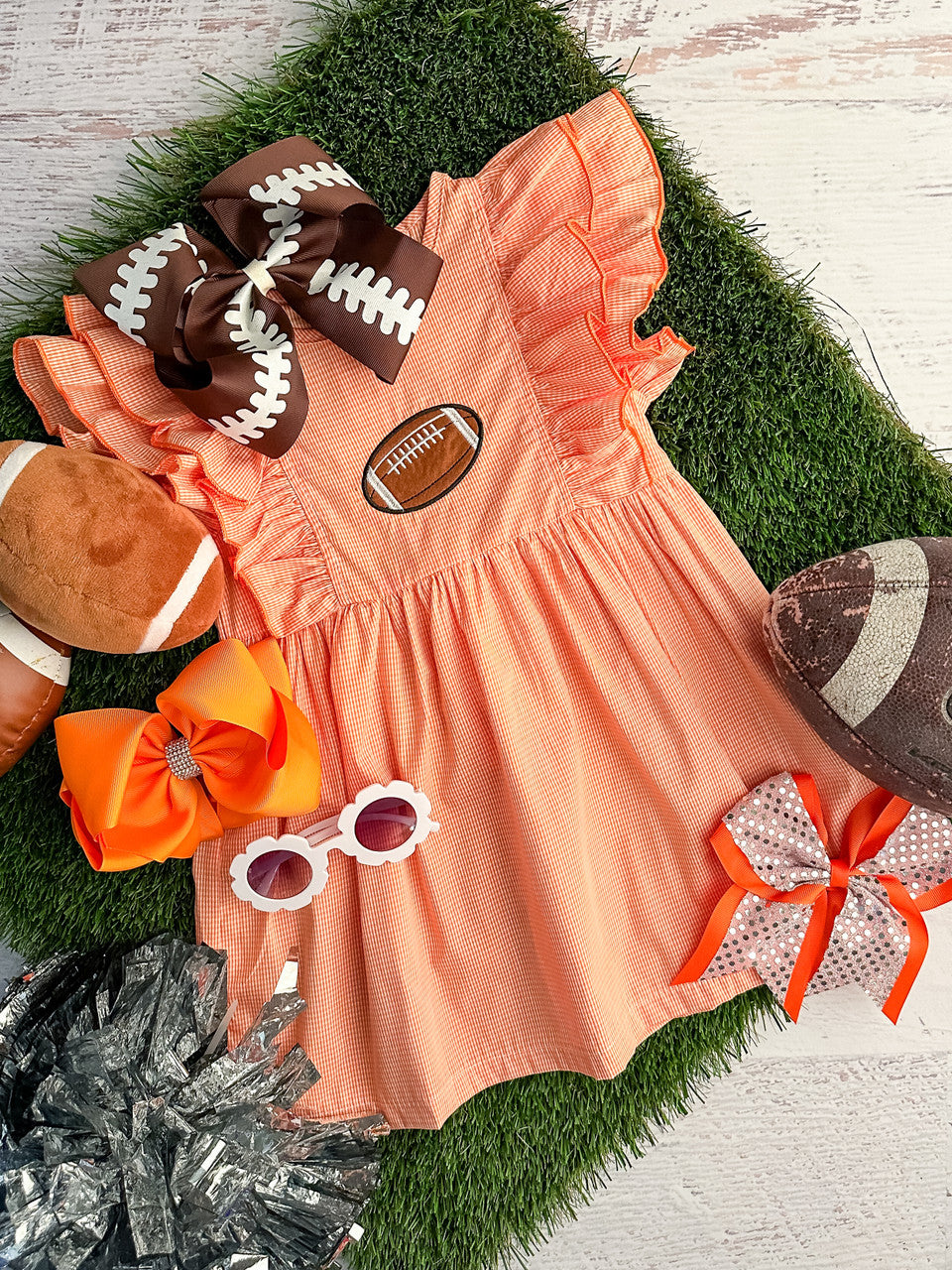 orange gingham dress with ruffle sleeves and football 