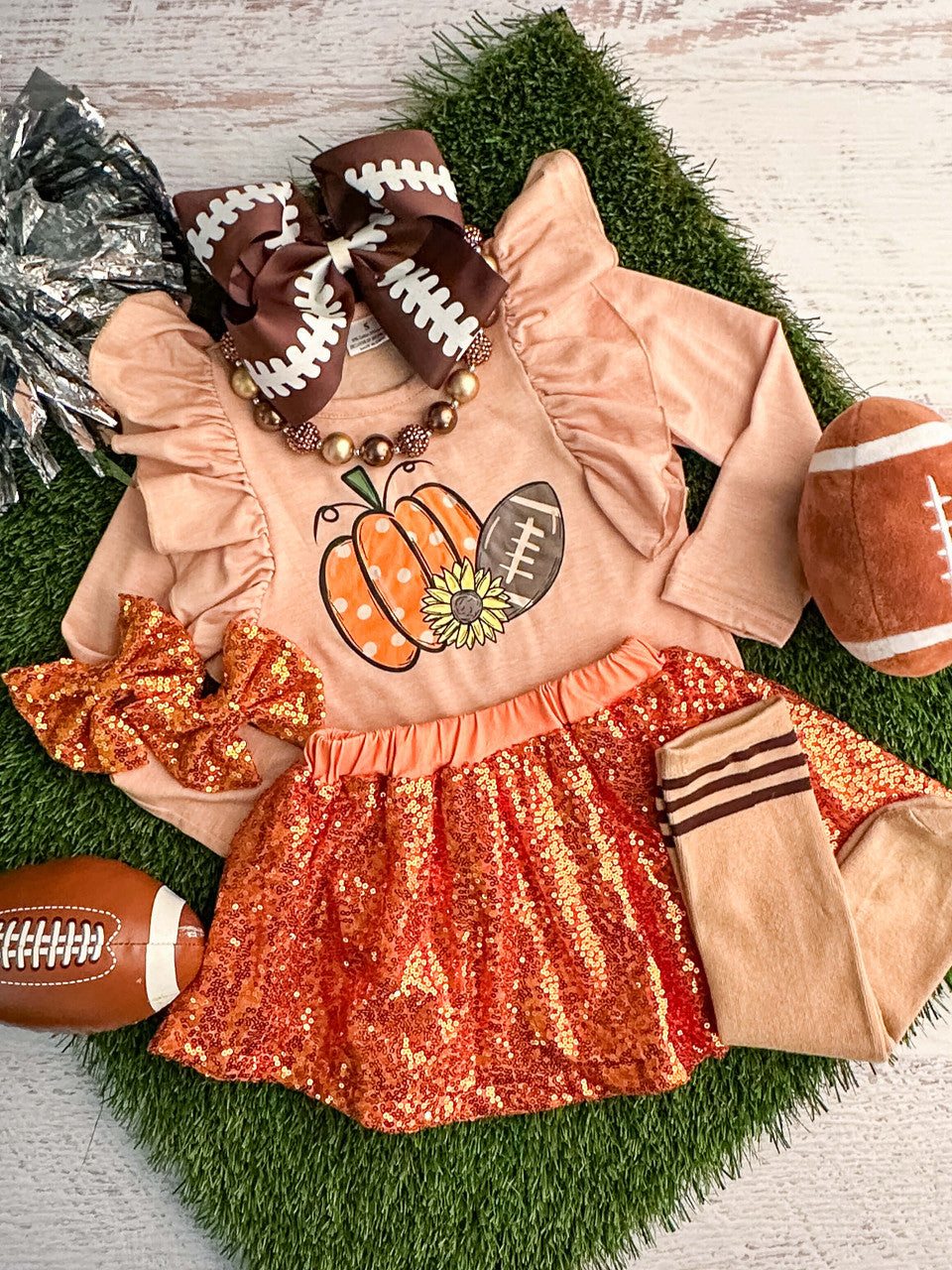 Long sleeve ruffled top with a football and pumpkin design with a coordinating orange sequin skirt