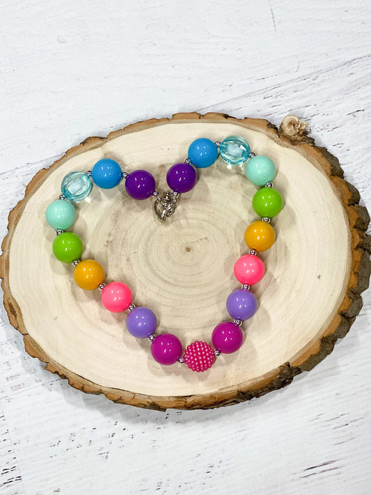 Chunky bead necklace in bright rainbow colors with heart clasp. Approximately 17".