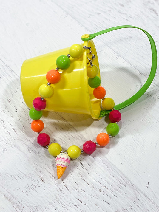 Cute ice cream pendant chunky bead necklace with pink, yellow, orange, and lime green beads and a heart toggle closure.
