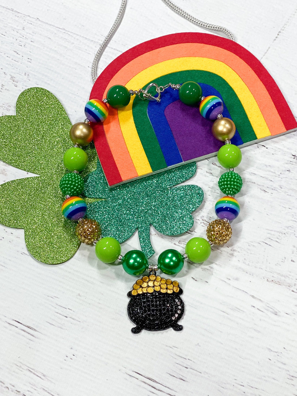 Pot of Gold chunky pendant with, rainbow beads, solid lime green, green, and gold paired with gold and green rhinestone beads with a heart toggle closure.