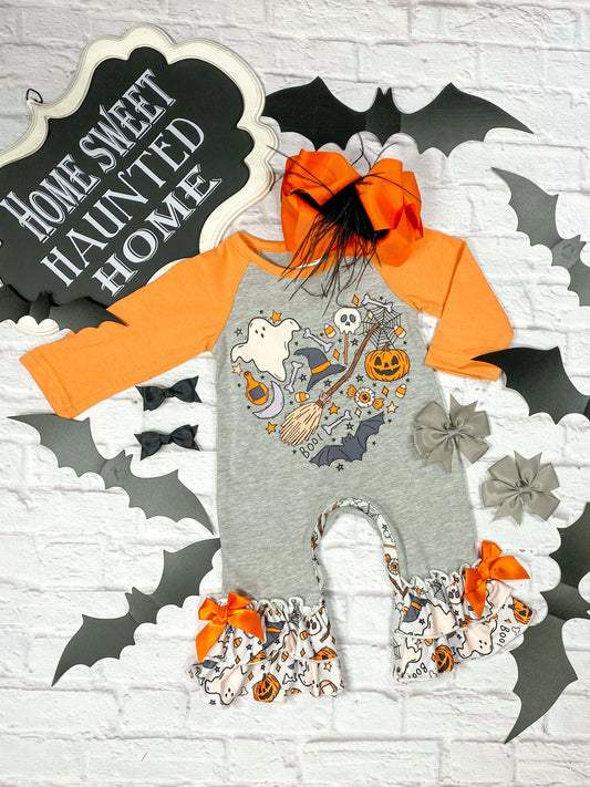 gray and orange baby romper with numerous halloween designs and ruffles