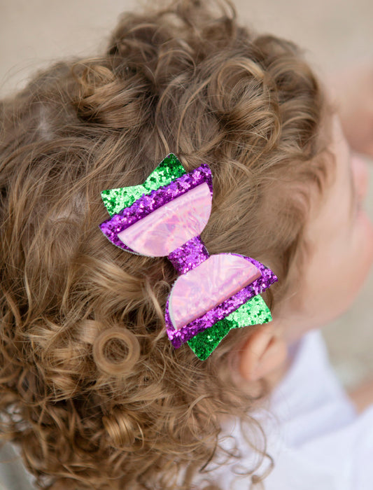 Iridescent mermaid bow with purple and green glitter- approximately 3 inches across.