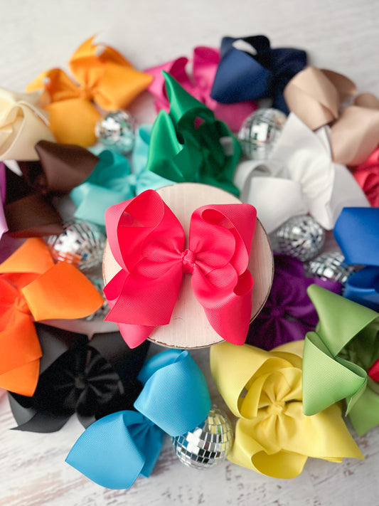 Oversize 5.5" hair bow for girls shown in 20+ colors