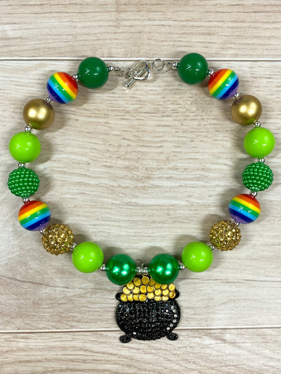 Pot of Gold chunky pendant with, rainbow beads, solid lime green, green, and gold paired with gold and green rhinestone beads with a heart toggle closure.