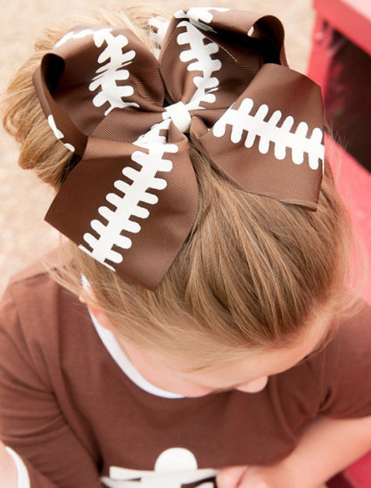 Football Texas size  hair bow for girls shown on model