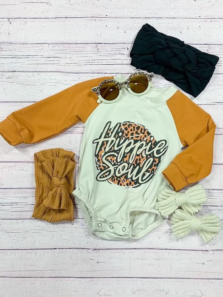 white and mustard baby romper with "hippie soul" screen print