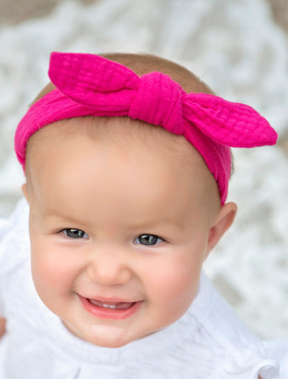 Knot headband on model shown in hot pink