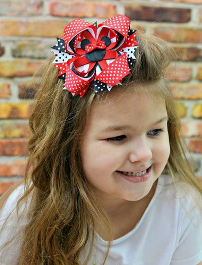 Polka dot Minnie Mouse hair bow in red on a model.
