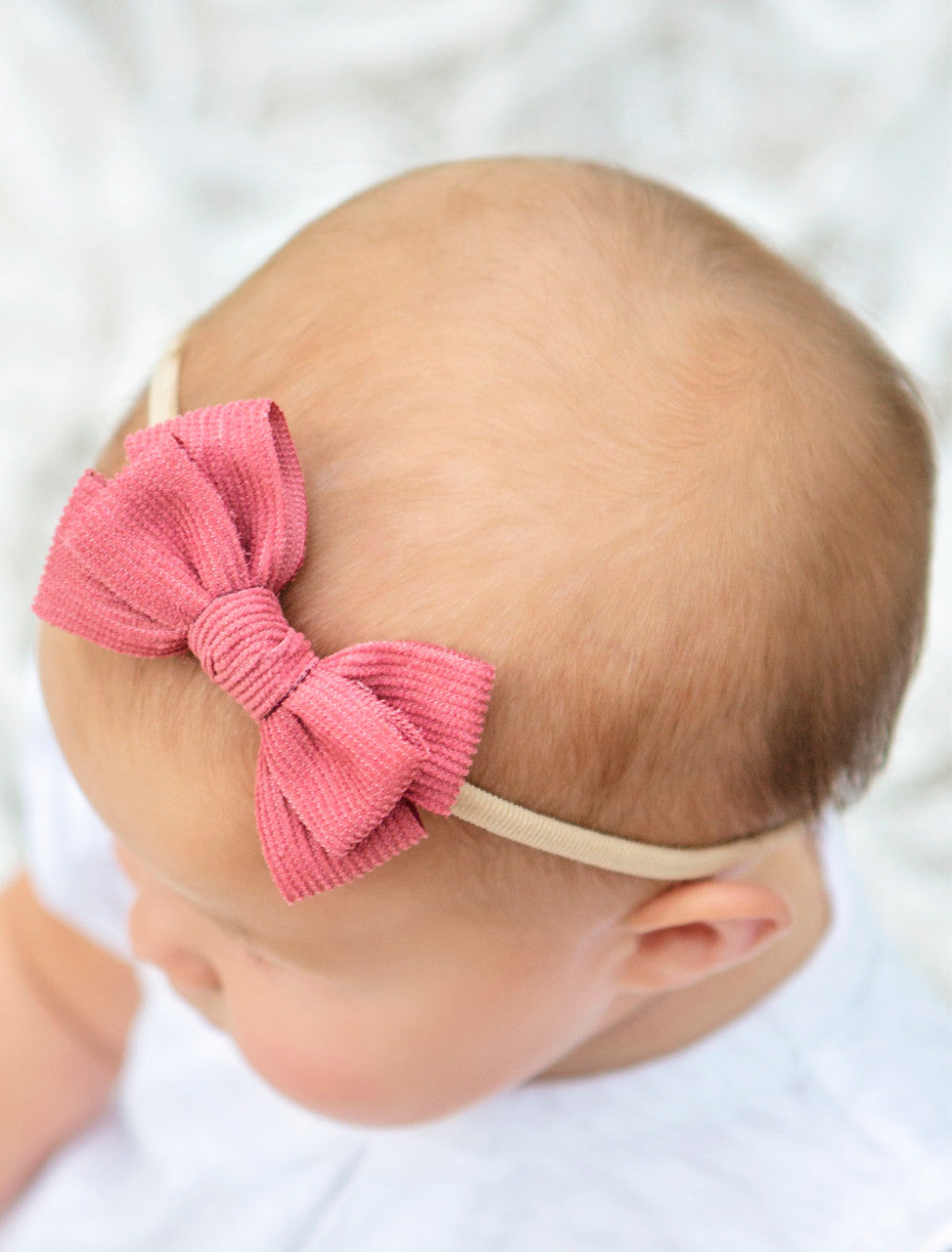 Stretchy corduroy bow headbands IN PINK ON MODEL