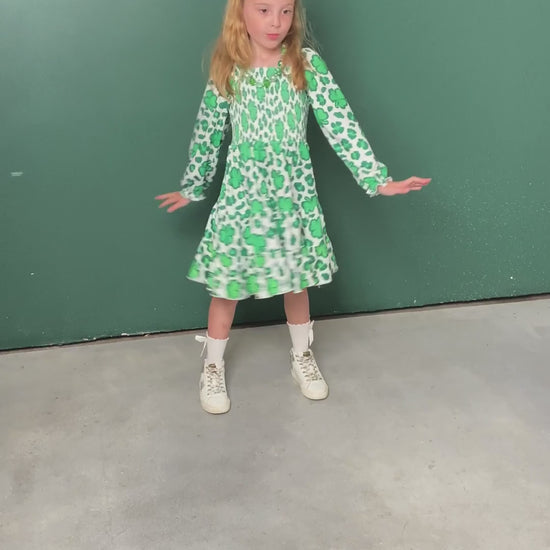 video of a model wearing our Lucky Clovers Smocked Twirl Dress