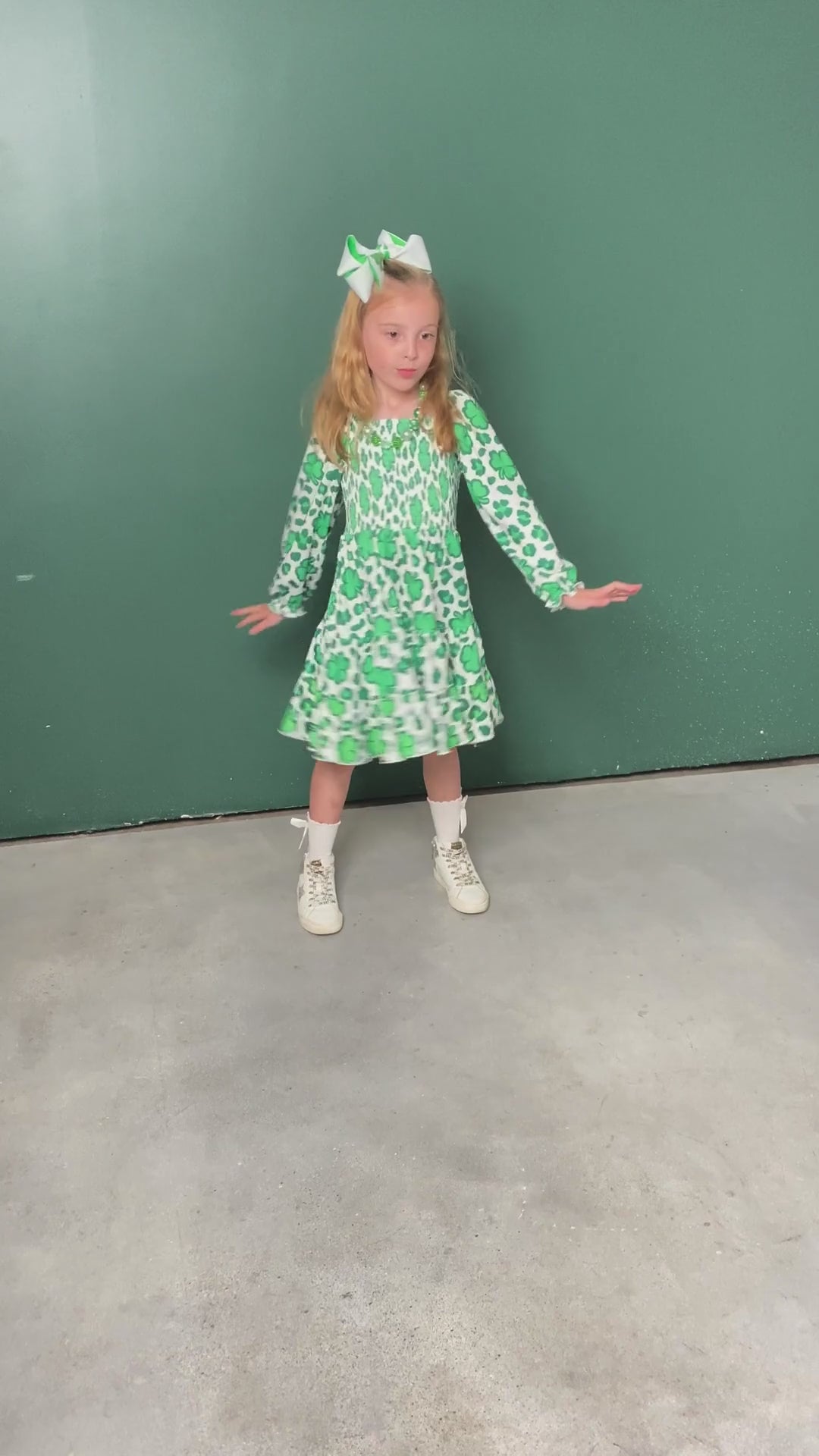 video of a model wearing our Lucky Clovers Smocked Twirl Dress