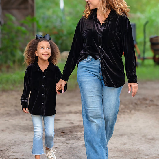 video of mom and daughter wearing black velvet tops