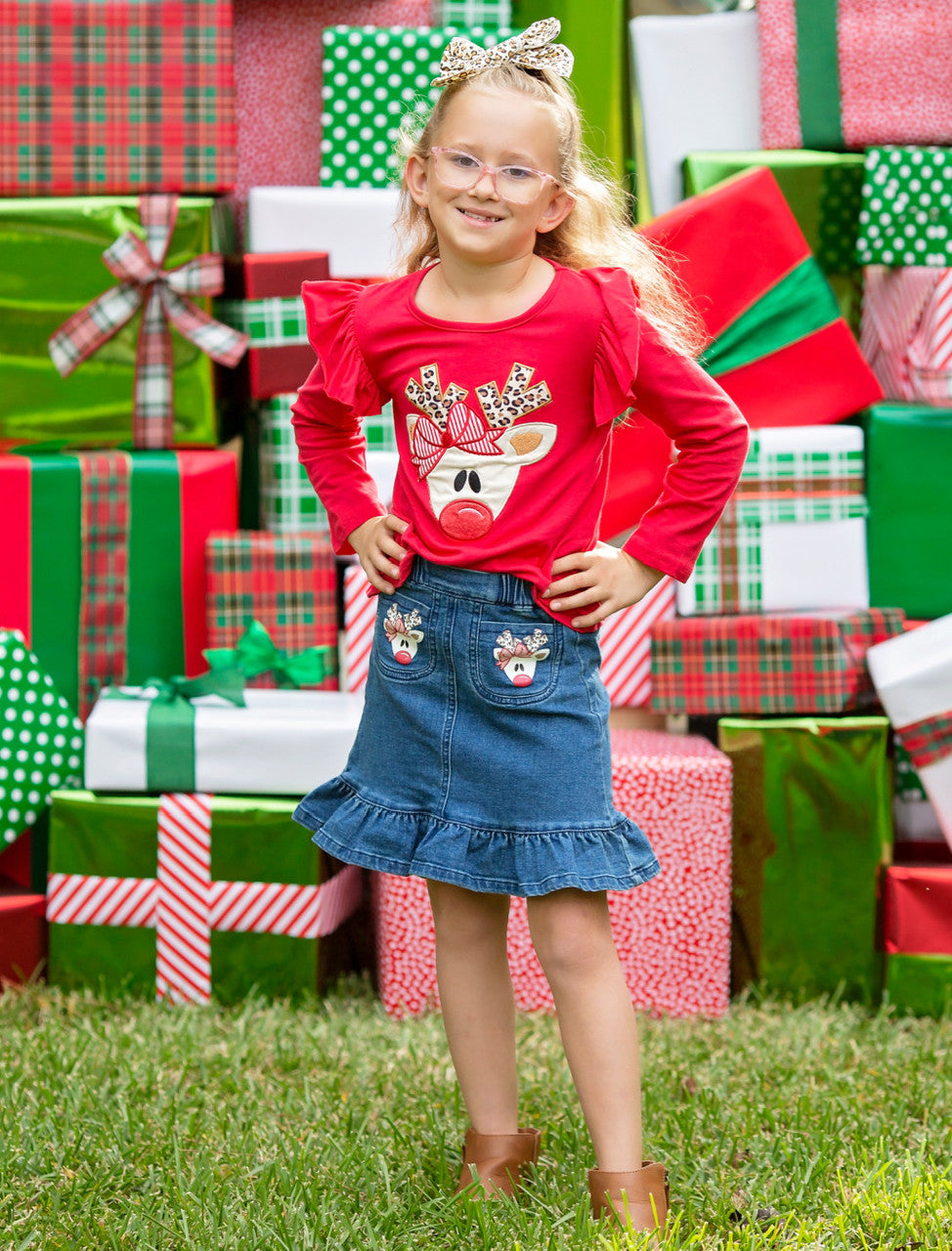 Model photo: This red cotton top features an adorable red nosed reindeer with animal print antlers applique and ruffled shoulders. The denim skirt is ruffled with reindeer on the pockets. 