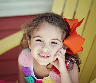 Texas size hair bow with French clip on a model