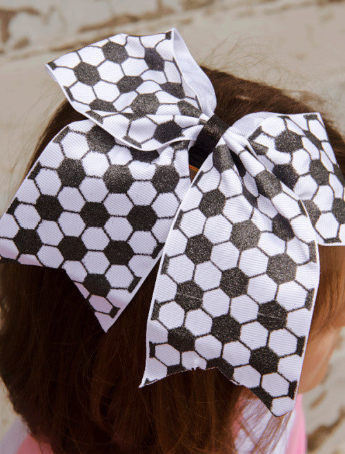 Soccer cheer bow for girls shown on child.